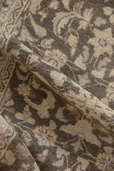 Detail of vintage distressed Hamadan rug pile, revealing even wear and floral vinery in earthy tones.
