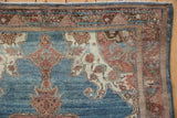 Distressed vintage Malayer rug border and abrashed blue field with scrolling motifs.