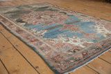 Distressed vintage Malayer rug side border with scrolling madder root and beige patterns.