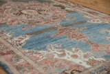 Distressed vintage Malayer rug with an abrashed blue field and madder root scrolling patterns.