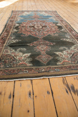 White fringe and secured brown side cord selvage on a vintage distressed Malayer rug.