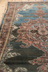 Distressed vintage Malayer rug detail showing abrashed sapphire blue and madder scrolling.