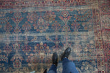 Distressed circa 1920s Yezd carpet with vinery, blossoms, and threadbare indigo blue field.