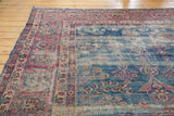 Vintage Fragment Yezd carpet displaying worn indigo and raspberry floral motifs.