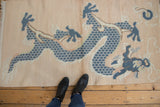 Distressed vintage Tibetan rug featuring fringe and dusty blue five-claw dragon motif.