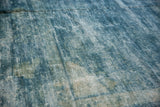 Distressed vintage Peking carpet showing worn pile and exposed foundation in blue shades.