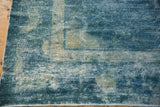 Mottled blue and pale tones on the distressed pile of a vintage Peking carpet.
