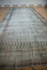 Angled view down the long distressed Malayer carpet, showing its soft time-worn pile.