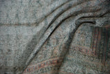 Textural detail of a distressed Malayer rug showing wear down to the grid-like foundation.