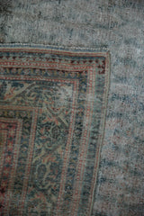 Exposed hand-knotted foundation and distressed pile at the corner of a vintage Malayer rug.