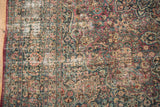 Distressed vintage Meshed carpet detail with intricate floral vinery and worn patina.