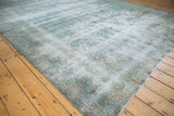 Vintage Distressed Kerman carpet featuring textured pile and faded blue floral motifs.