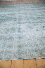 Vintage distressed Kerman carpet texture with large areas of foundation showing through, featuring blues and ivory.