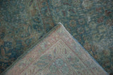 Distressed Kerman carpet pile with visible foundation, revealing raspberry floral pattern on the reverse.