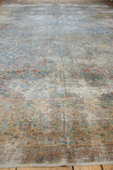 Worn tree of life motif, dragon border, and visible foundation on distressed Kerman carpet.