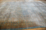 Distressed Kerman carpet corner, visible foundation, worn tree of life motif, and dragon border.