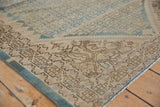 Corner of distressed Malayer rug, showing intricate Herati motif with even wear.