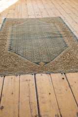 Distressed Malayer rug with even wear, featuring blue Herati field and ivory corner.