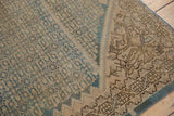 Distressed vintage Malayer rug, showing intricate brown border and blossoming corner.