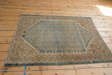 Distressed texture and time-softened dusty blue and ivory Herati motifs on a vintage Malayer rug.