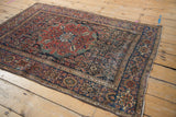 Madder red Herati motif, floral main border, and visible wear on this antique Farahan Sarouk rug.