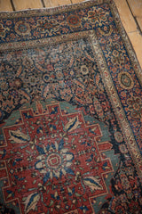 Antique Farahan Sarouk rug: madder red medallion, Herati field, distinct foundation wear.