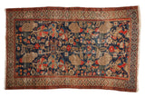 Vintage Hamadan rug with bursting pomegranate and leaf design in navy blue, red, and beige.