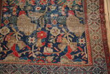 Navy, red, beige bursting pomegranate motif on worn Hamadan rug, faint foundation visible.