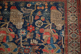 Vintage Hamadan rug border detail: red serrated design, tribal beige, and worn navy field.
