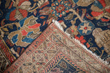 Vintage Hamadan rug's worn navy, red pile and its woven foundation.