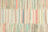 Hand-woven flatweave showing joined panels and colorful striped texture.