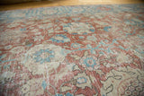 Detailed view of the distressed, low pile showing time-softened red and blue palmettes.