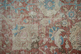 Distressed low-pile texture of a vintage Tabriz rug with pale red and blue palmettes.