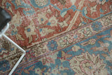 Distressed pile on a vintage Tabriz showing faded palmettes in sky blue and celadon red.
