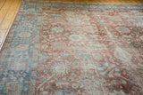 Decorative, distressed texture of a vintage Tabriz carpet with pale red and sky blue palmettes.