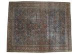 Distressed vintage Joshegan carpet, central quatrefoil, intricate garden pattern, faded sapphire blue, ruby red.
