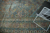 Distressed vintage Joshegan carpet border with vivid sapphire blue and ruby red floral motifs.