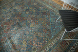Distressed vintage Joshegan carpet featuring intricate floral patterns in sapphire blue and ruby red.