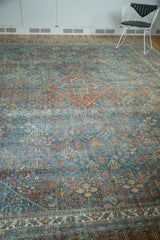 Distressed Joshegan carpet close-up, intricate Persian botanical design with sapphire and ruby tones.