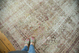 Distressed antique Kermanshah rug, faded raspberry mil fleur patterns with exposed foundation.