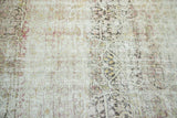 Exposed foundation and ghostly mil fleur patterns on a distressed antique Kermanshah carpet.