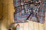 Antique Kurdish rug: tribal Herati pattern in dark navy, madder red, and sky blue.