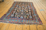 Antique Kurdish tribal rug's fringed end, with light blue and red borders, Herati motifs.