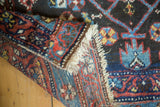 View of antique Kurdish rug corner showing Herati pattern, original selvage, and woven reverse.