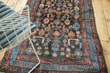 Antique Kurdish rug: intricately woven Herati pattern with navy, madder red, sky blue, saffron.