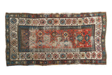 Antique Caucasian Kazak runner, geometric panels in terra cotta, blue, ivory. Time-softened.