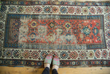 Detail of antique Caucasian Kazak runner, geometric panel design with etched red, blue, and cream.