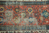 Distressed foundation and geometric panels on an antique Caucasian Kazak rug.