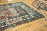 Hand-knotted Caucasian Kazak runner border, geometric panels in aged terra cotta, blue, ivory.