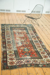 Antique Caucasian Kazak runner corner with geometric borders, barber pole lattice, time-softened colors.